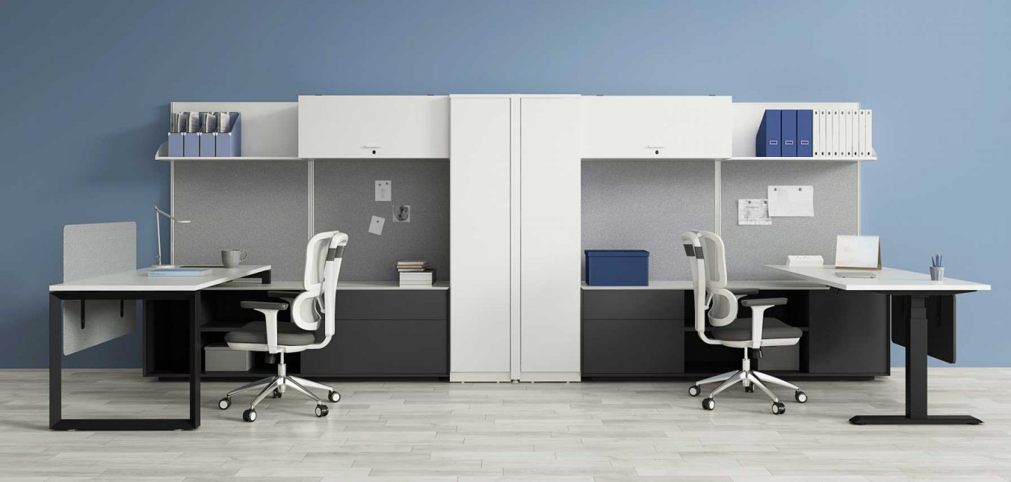 shared office workspace with desks, chairs, and storage
